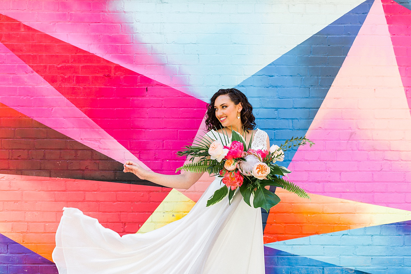 Colourful mural bridal portrait. Tropical inspired bouquet.