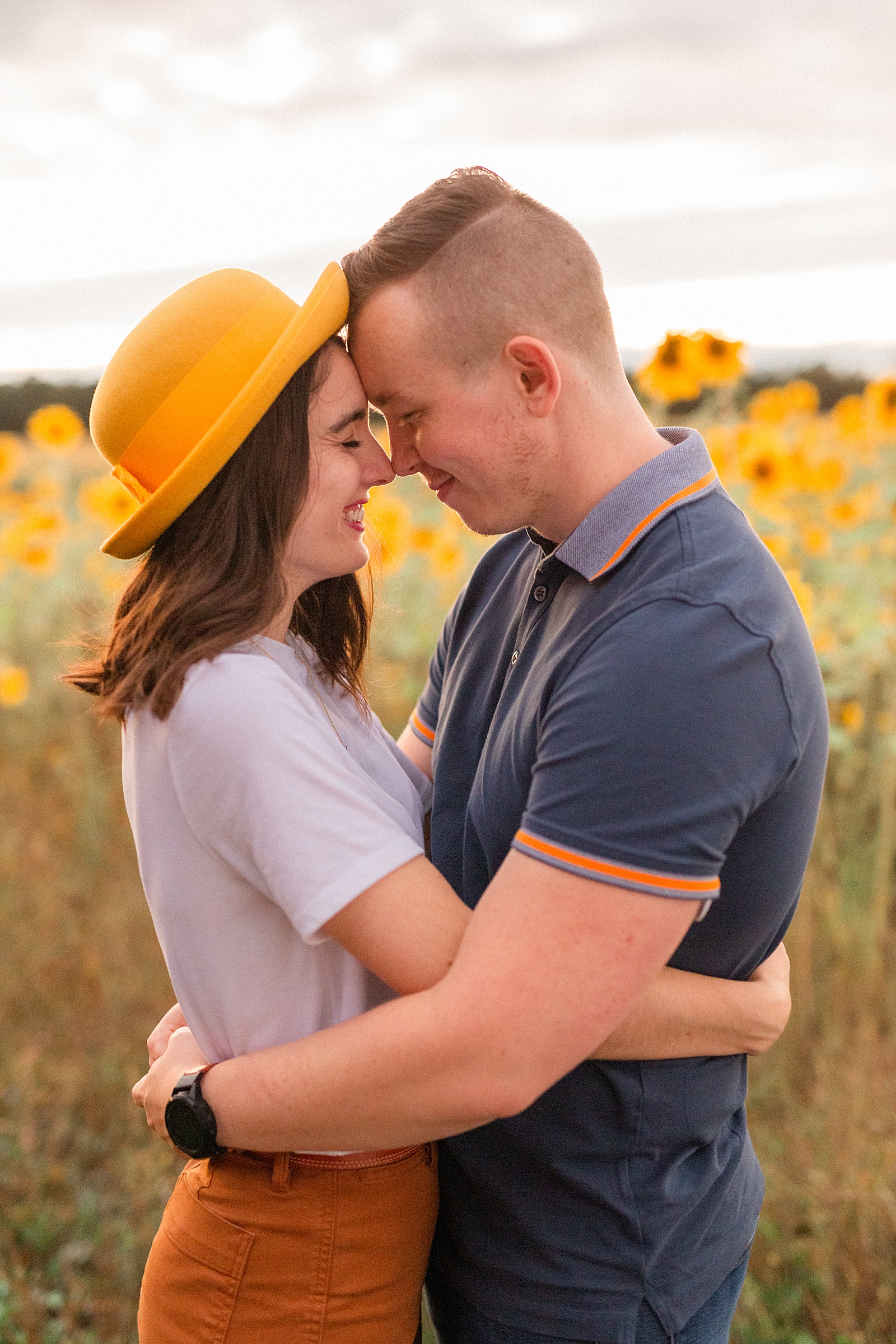 Engagement session in a sunflower field at sunset