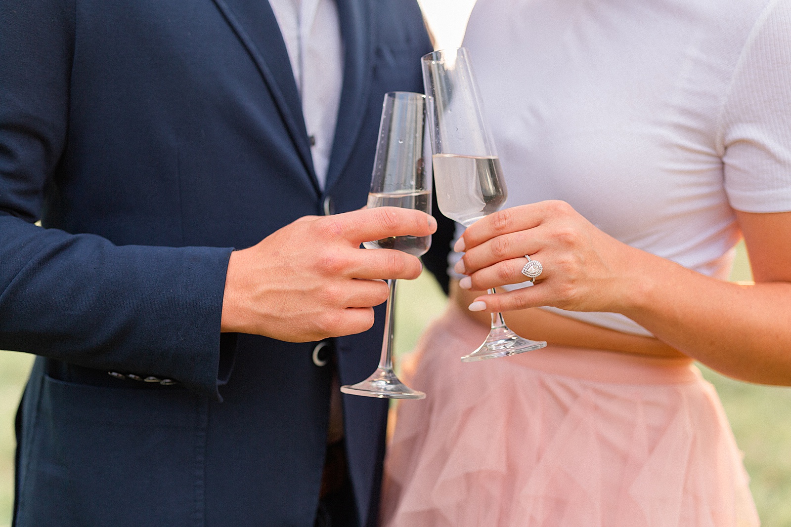 Champagne glasses and engagement session ring