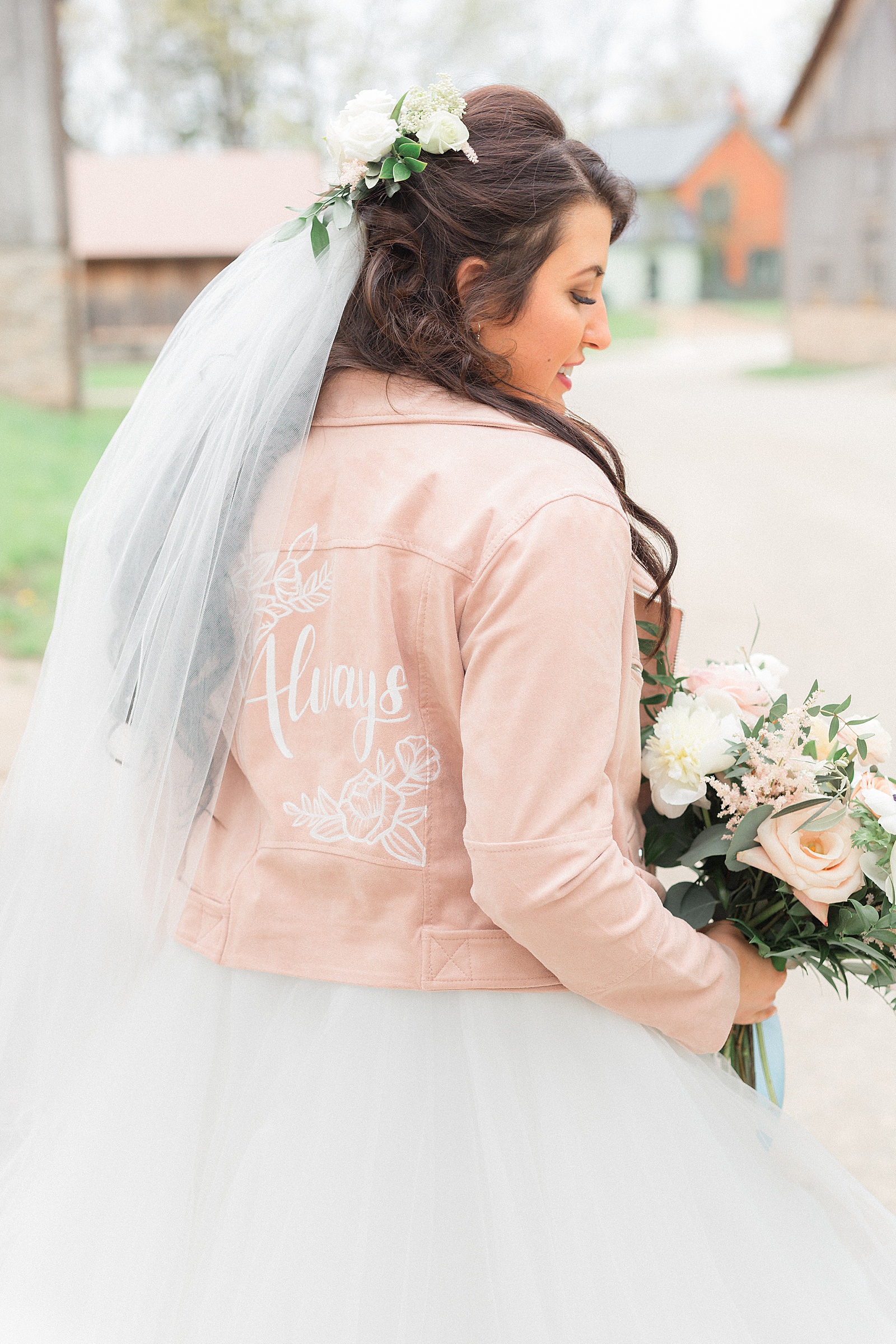 Bride wearing calligraphed jacket