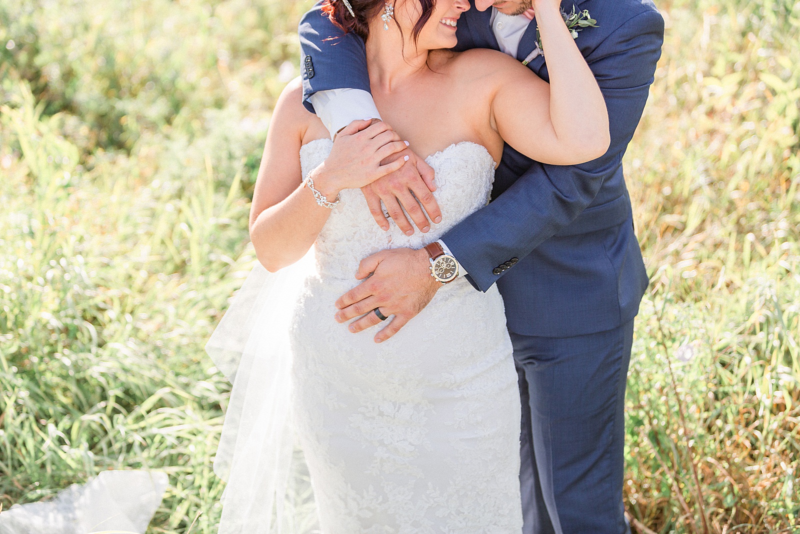 Bride and groom hugging in a field in Waterloo Ontario